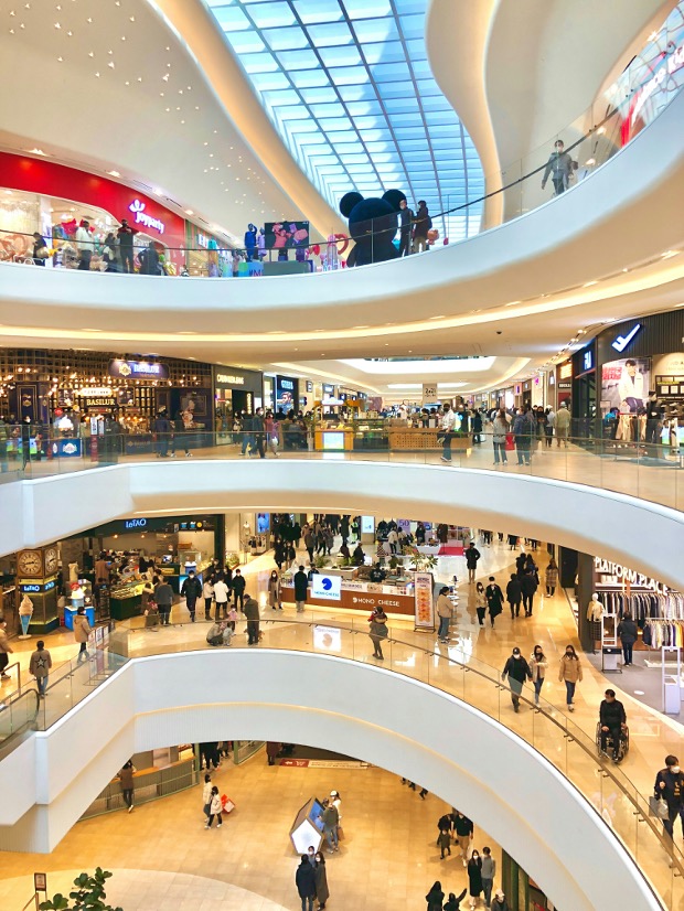 Shoppers in a busy shopping mall atrium